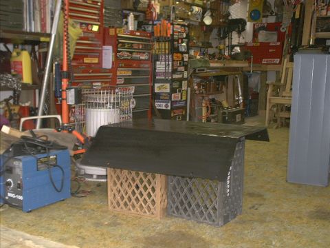 1978 Ford Bronco - A makeshift workbench is assembled in a garage, surrounded by tools and equipment.