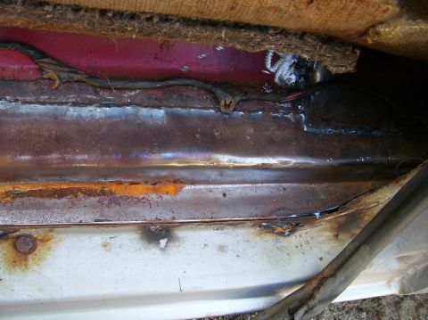 1984 Ford Bronco - Detail of rust and exposed wiring within the vehicle's interior.