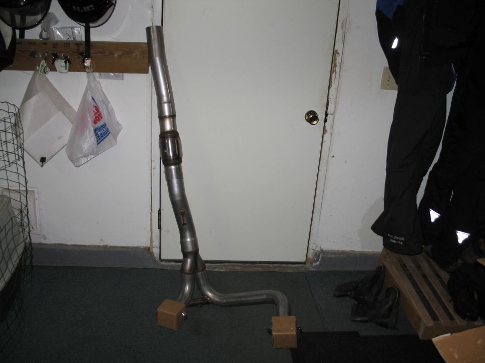 Fabricated exhaust Y-pipe with catalytic converter propped in a garage