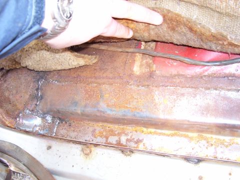 1984 Ford Bronco - This photo shows significant rust and repair work on a vehicle's floor pan, indicating potential structural issues.