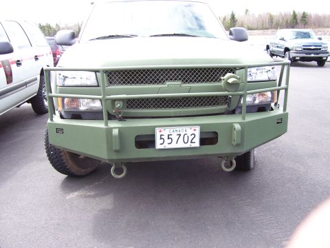 1984 Ford Bronco - This truck features a heavy-duty brush guard and winch, with a Canadian license plate visible on the front.