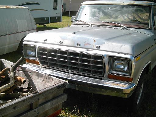 Silver Ford truck front end with a large grille and visible 'FORD' lettering