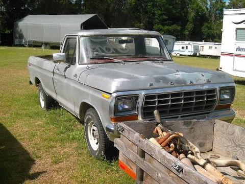 1986 Ford Bronco - This silver pickup truck, seen from a 3/4 front angle, appears to be from the 1970s based on its grille design.