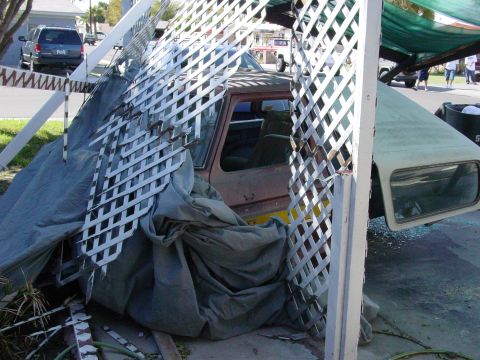 1979 Ford Bronco - 1979 Ford Bronco seen from the side, obscured by a tarp and white lattice structure.