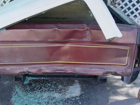 1979 Ford Bronco - This damaged vehicle's rear quarter panel displays extensive dents and broken glass, suggesting a recent collision.