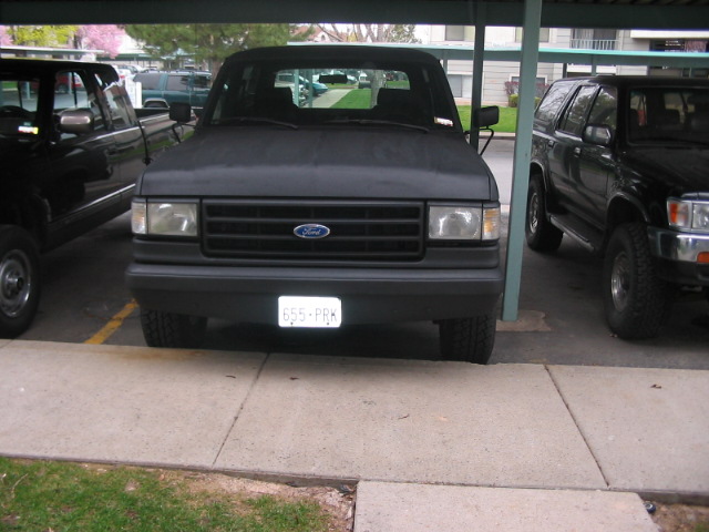 Front view of a black 1991 Ford Bronco with a license plate reading 655-PRK