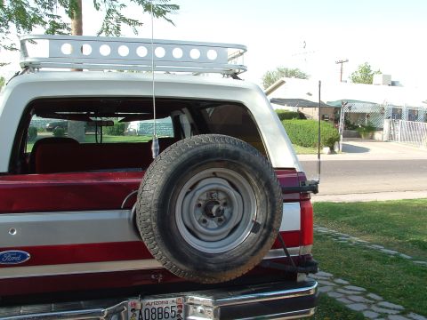 1990 Ford Bronco - Rear view of a 1990 Ford Bronco, complete with a roof rack and external spare tire.