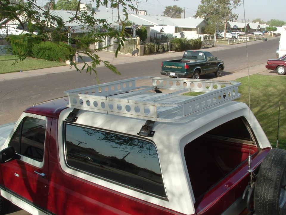 Red and white Bronco with custom aluminum roof rack, viewed from above rear quarter