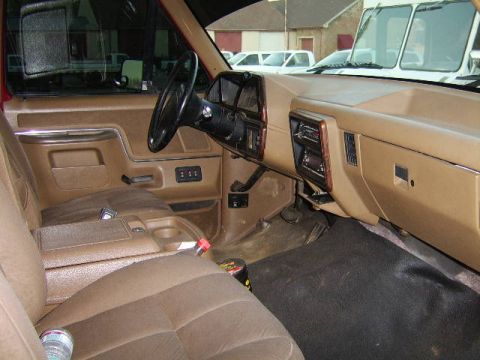 1989 Ford Bronco - Interior view of a 1989 Ford Bronco, showing the tan seats, dashboard, and center console.