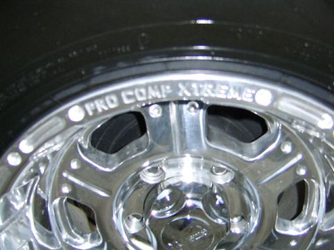 1989 Ford Bronco - Close-up of a chrome wheel and tire, showing 'PRO COMP XTREME' branding.