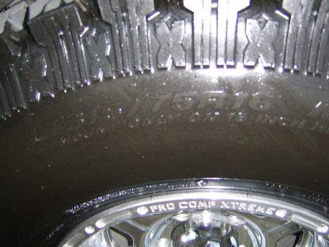 1989 Ford Bronco - A close-up shot focuses on the tread and sidewall details of a Pro Comp Xtreme tire, with the wheel also visible.