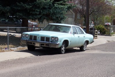 1972 Ford Ranchero - This 1975 Oldsmobile Delta 88 sedan is parked on the side of a street.
