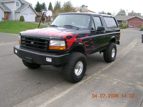 1996 Ford Bronco - This lifted Ford Bronco features custom flame decals on its hood and sides.