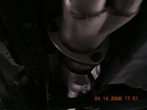 1996 Ford Bronco - Underside view of a vehicle's exhaust system connection.