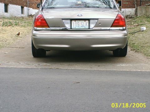 2000 Ford Crown Victoria - Rear view of a tan 2000 Ford Crown Victoria parked on a driveway.