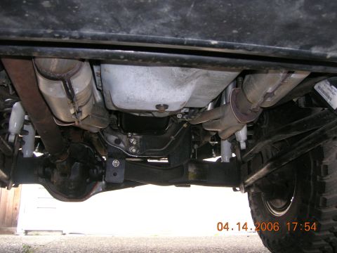 1996 Ford Bronco - Undercarriage of a 1996 Ford Bronco, focusing on the exhaust system and rear suspension components.
