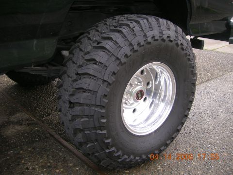 1996 Ford Bronco - A close-up view of a off-road tire and custom wheel mounted on a vehicle.