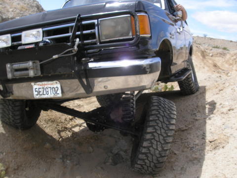 1988 Ford Bronco - This 1988 Ford Bronco is navigating a rocky, off-road trail with a clear blue sky above.