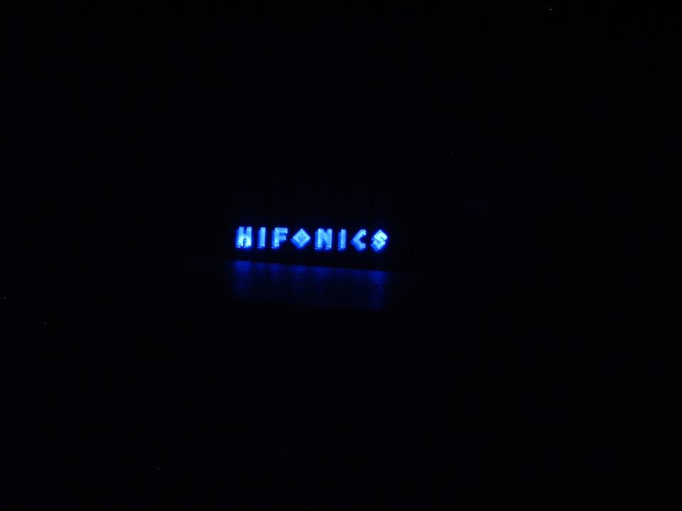 Blue illuminated HIFONICS logo on a black background
