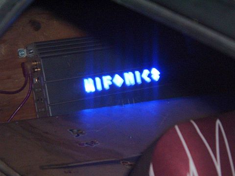 1994 Ford Thunderbird - A car amplifier with a glowing blue logo is visible, mounted inside a vehicle.