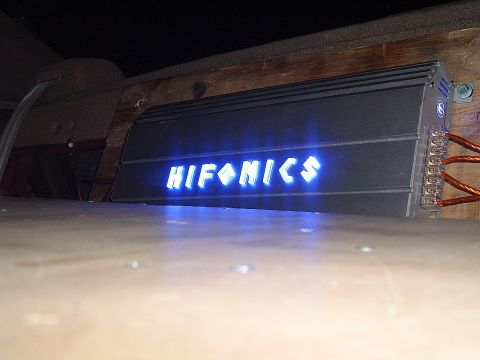 1994 Ford Thunderbird - A car amplifier with a glowing blue logo is visible, mounted in what appears to be a vehicle's interior.