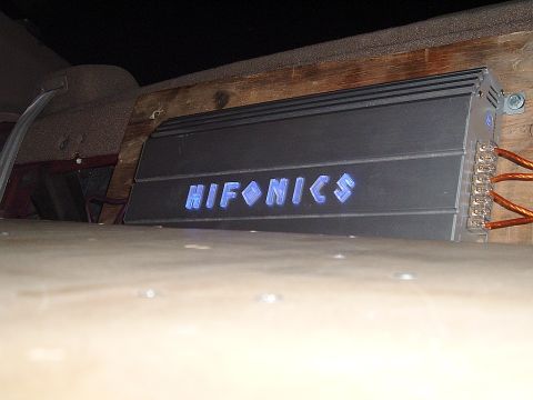 1994 Ford Thunderbird - A car amplifier with the brand name 'HIFONICS' illuminated in blue is mounted inside a vehicle.
