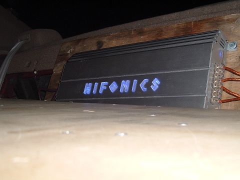 1994 Ford Thunderbird - Hifonics car audio amplifier installed in a vehicle's interior, showing wiring terminals.