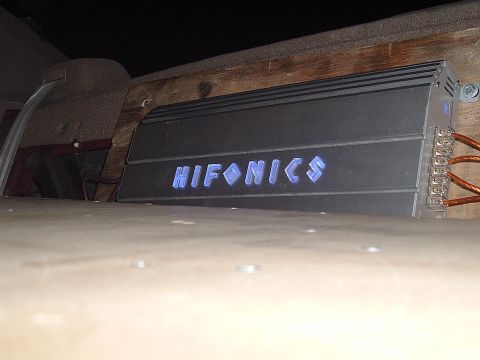 1994 Ford Thunderbird - A Hifonics amplifier is installed in a vehicle, with its illuminated logo visible.