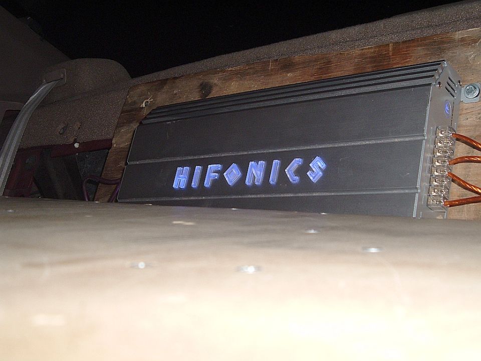 Hifonics amplifier with blue illuminated logo mounted in a vehicle