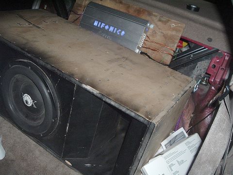 1994 Ford Thunderbird - Custom subwoofer enclosure and audio amplifier are visible in the cargo area of a vehicle.