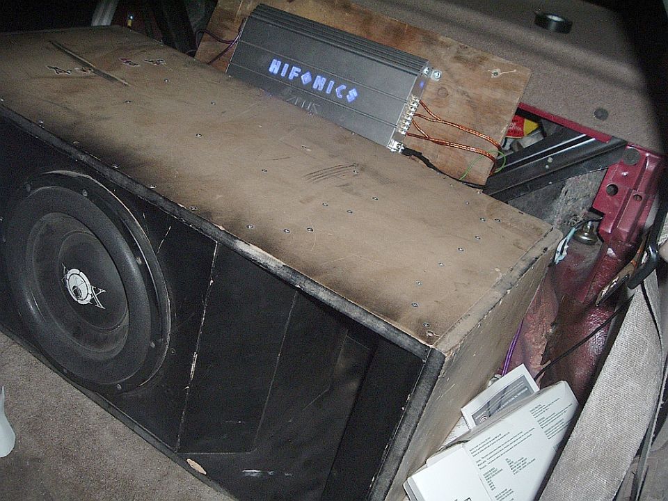 Subwoofer box and Hifonics amplifier installed in a car trunk