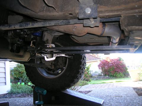 2002 GMC Yukon - Underside view of a vehicle, focusing on the exhaust system and suspension parts.