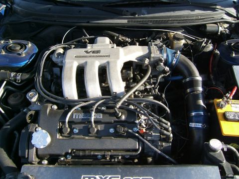 1996 Ford Probe - The engine bay shows a Mazda V6 engine, identified by the 'Mazda' text on the valve cover and the 'V6 DOHC 24 VALVE' inscription on the int…