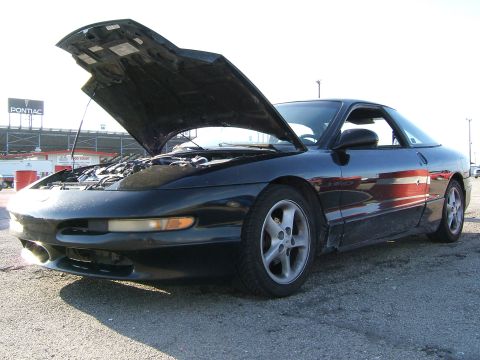 1996 Ford Probe - A black 1996 Ford Probe is shown with its hood open, revealing the engine compartment.