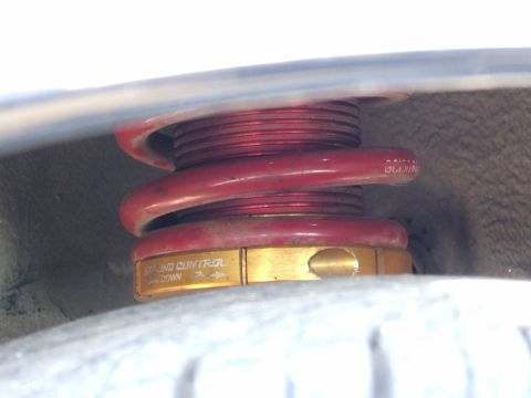 1996 Ford Probe - A close-up view of a red coilover suspension component with adjustable ride height.
