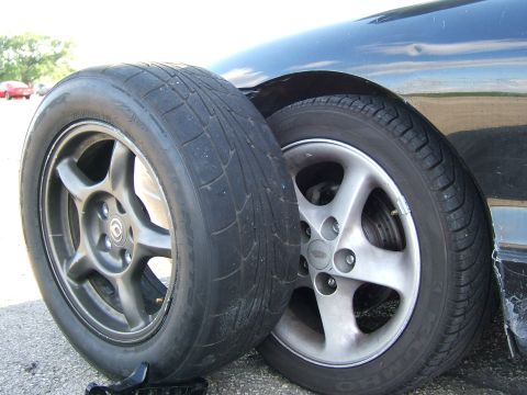 1996 Ford Probe - A car's tires are shown, with one tire exhibiting significant wear.