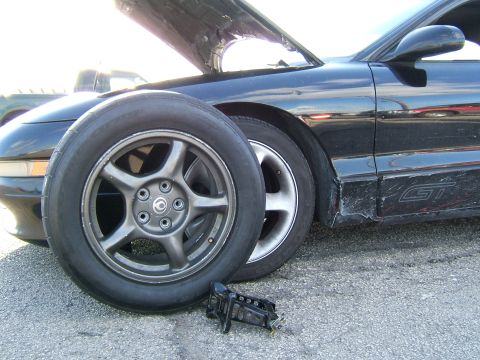 1996 Ford Probe - A black 1996 Ford Probe GT is shown with its hood up and a spare tire placed in front of the driver's side wheel.