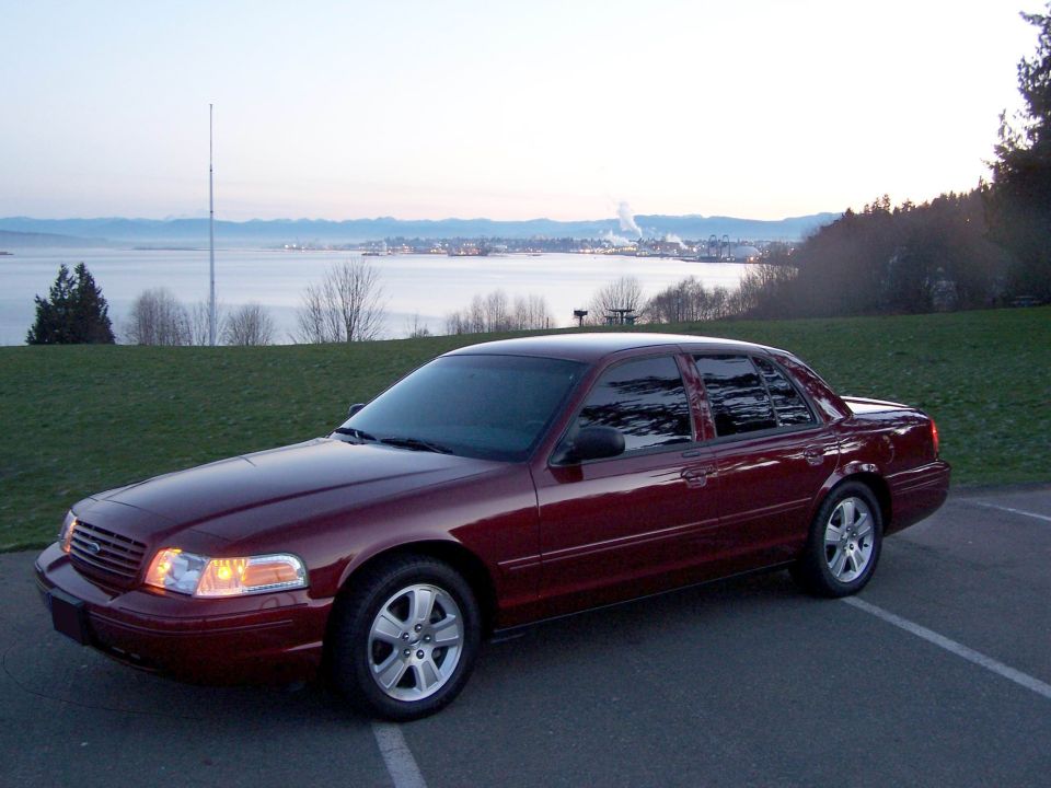 Maroon 2005 Ford Crown Victoria parked with a scenic water view