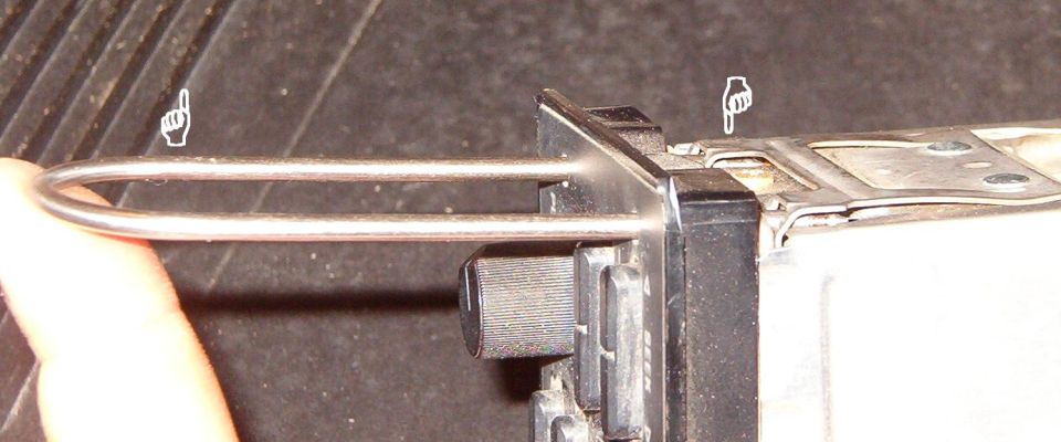 Pull the tools outboard to fully compress the catches, then pull the tools to draw the radio out of the dash.  If you're using improvised tools, either grab in the cassette door, or use another tool to pry the radio face out gently & evenly.