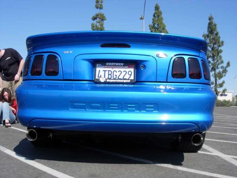 1998 Ford Crown Victoria - The rear of a blue 1998 Ford Mustang Cobra, SVT badging and "COBRA" embossed on the trunk lid.