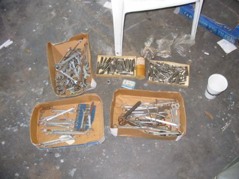 1997 Ford Crown Victoria - Collection of various tools, including wrenches, organized in cardboard boxes on a floor.