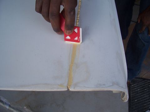 1978 Ford Bronco - Sealing a seam on a fiberglass panel with a specialized tool.