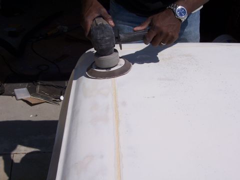 1978 Ford Bronco - Sanding a fiberglass part with an orbital sander.
