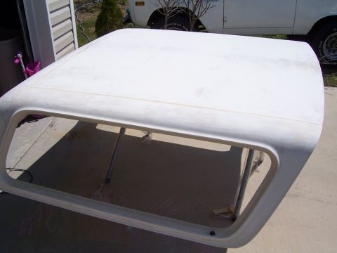 1978 Ford Bronco - A white fiberglass top, likely for a Ford Bronco, is shown outdoors.