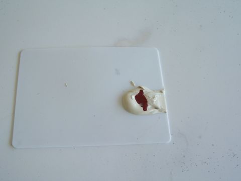 1978 Ford Bronco - A white plastic part is shown with a dollop of putty and a red substance.