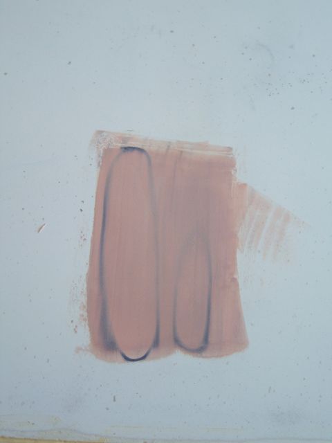 1978 Ford Bronco - A patch of pink paint with dark outlines is visible on a light blue wall.