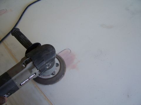 1978 Ford Bronco - A Porter-Cable angle grinder is being used to sand a surface, leaving behind pink dust.