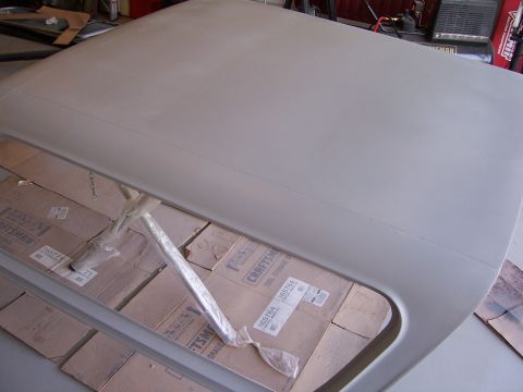 1978 Ford Bronco - Large gray primered sheet-metal panel laid across Craftsman boxes in a workshop.