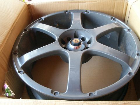 1995 Ford Probe - A single gray aftermarket car wheel is shown inside a cardboard box, ready for shipping or storage.