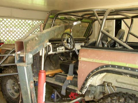 1995 Ford Bronco - Interior view of a modified Ford Bronco, showing a roll cage and custom modifications.
